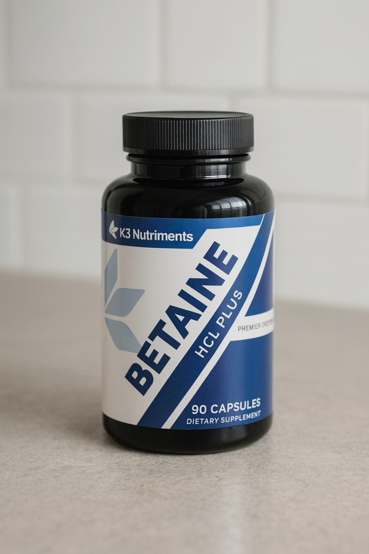 A bottle of K3 Nutriments Betaine HCL Plus on a kitchen counter, representing the comparison of betaine vs betaine hcl in supplement form.